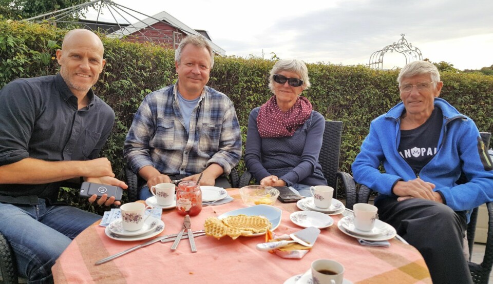 Fra venstre: Martin Ellingsen, styreleder i Lindøya vel, Lars Askholt, og ekteparet Marit og Arne-Erik Ellingsen, i hagen til Ellingsen-hytta på Lindøya. Plan og bygg vil tvangsflytte hytta deres. Foto: Tarjei Kidd Olsen
