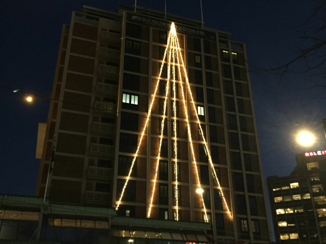 På fasaden til gamle Hotel Royal Christiania lyser et juletre opp. Foto: Privat