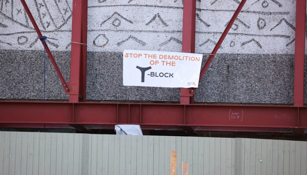 Aksjonisten deltok tidligere i en teltleir foran bygget. Banneret har teksten «Stop the demolition of the Y-block». Aksjonisten deltok tidligere i en teltleir foran bygget. Banneret har teksten «Stop the demolition of the Y-block».
