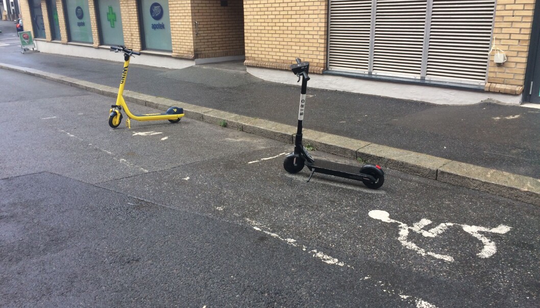 Her står elsparkesyklene i hver sin lomme for handikap-parkering. Her står elsparkesyklene i hver sin lomme for handikap-parkering.