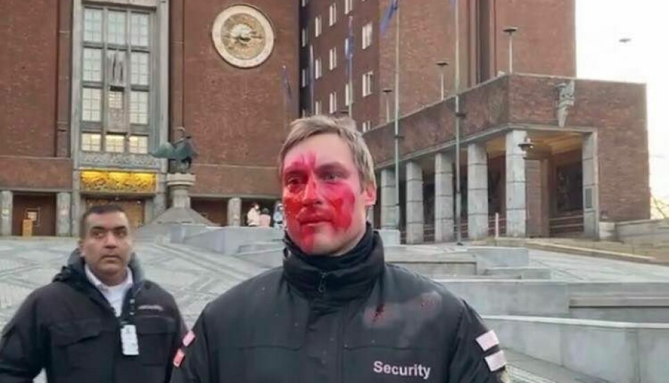 Bildet viser tydelig at mannen har blitt sprayet med rødfarge i ansiktet.