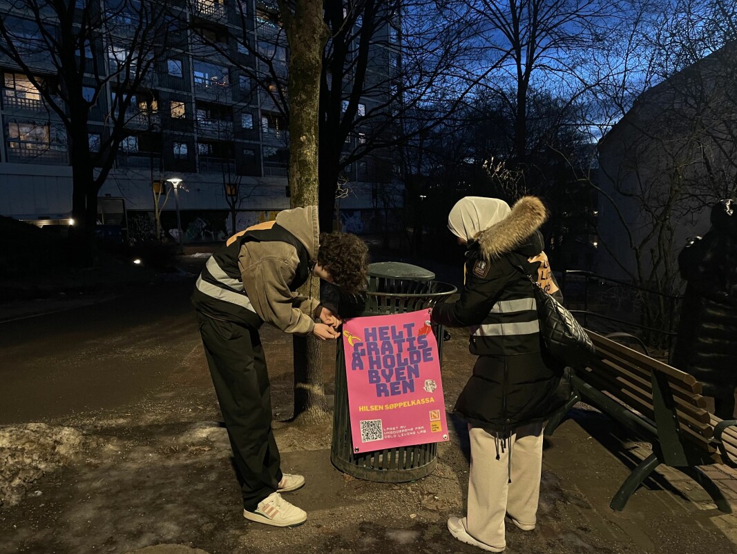 Juniorforskerne Julian Brito-Benestad og Hanan Zag henger opp plakater på Gartnerløkka ved Enerhaugblokkene. Juniorforskerne Julian Brito-Benestad og Hanan Zag henger opp plakater på Gartnerløkka ved Enerhaugblokkene.