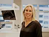 Kvinne står foran en PC-skjerm